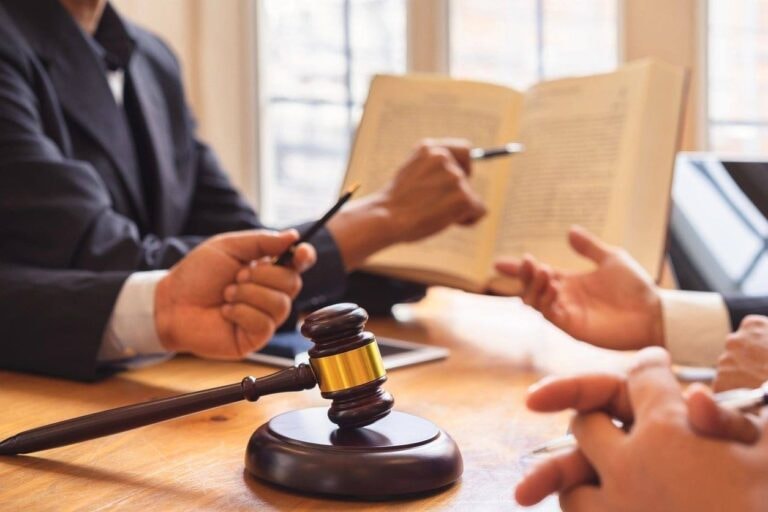 Legal consultation with gavel and attorneys reviewing documents