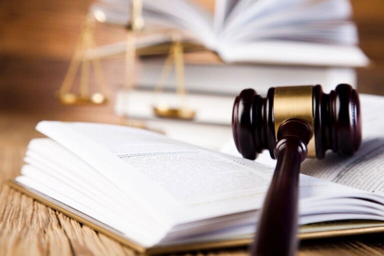 Gavel resting on open law books with scales of justice